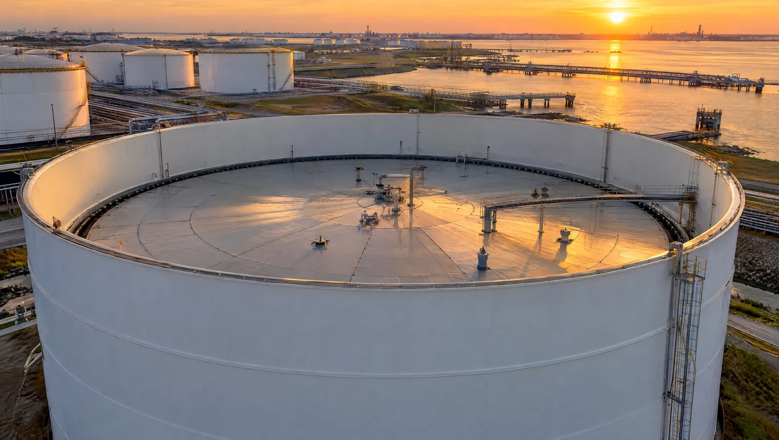 Aerial view of a floating roof storage tank at golden hour